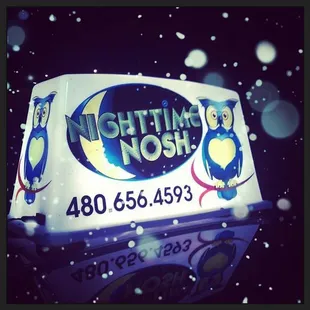 an ice cream truck with a penguin on it