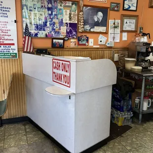 a counter with a sign on it