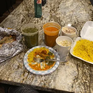 Family meal: spinach and chicken tikki masalla, 2types naan, rice, cabbage salad and dessert. Generous portions, amazing flavor!