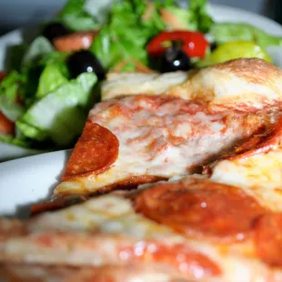 a plate of pizza and a salad