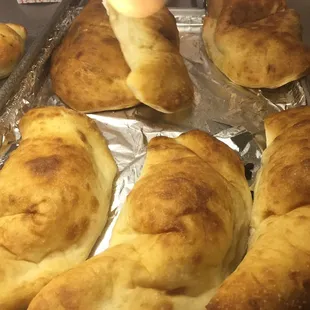 a person placing a piece of bread into a pan