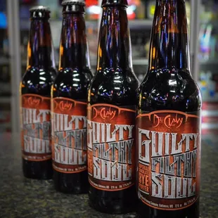four bottles of beer on a counter