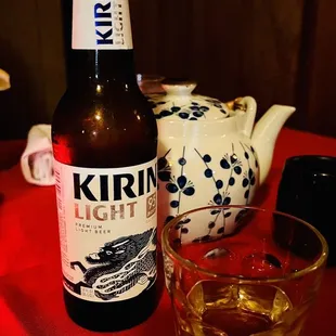 a glass of whisky and a teapot