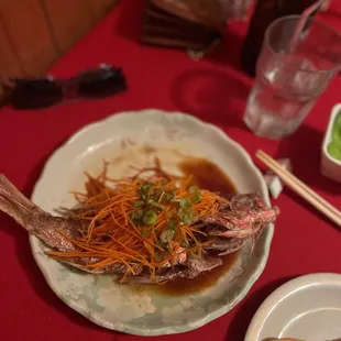a plate of fried fish on a table