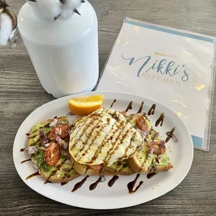 Avo toast with tomatoes fried egg and balsamic