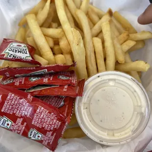 a basket of french fries and a cup of ketchup