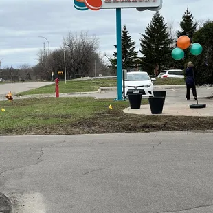 a woman standing in front of a sign