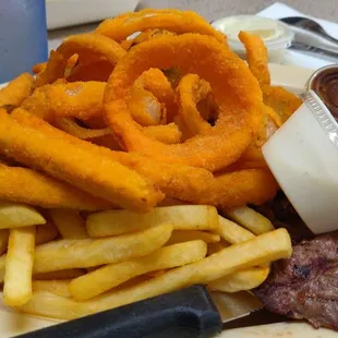 Tons of fries, zucchini, and onion rings covered my steak. The steak is larger than pictured and much more tender than I expected.