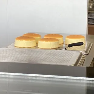 Whole soufflé cheesecakes awaiting for their packages