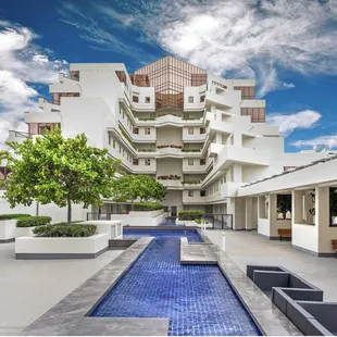 Exterior shot of apartment complex in Honolulu with example of Sky Replacement on editing