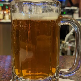 a glass of beer on a napkin