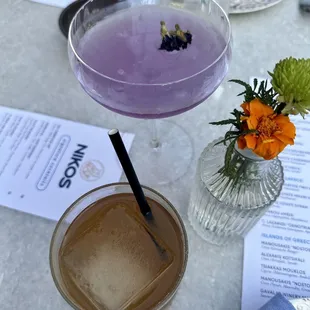 a purple drink in a glass on a table