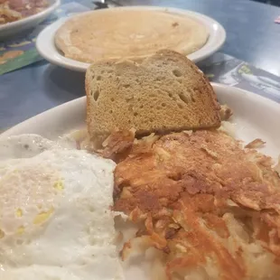 Two eggs over medium.  Hash browns extra crispy , rye toast and one pancake.