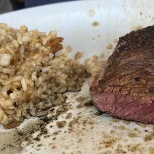 This was the Cajun-style rice &amp; ribeye steak after the plate was split into 2 plates.  Steak is perfectly cooked for medium-rare.