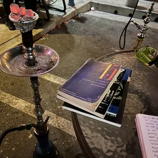 a glass of wine and a book on a table