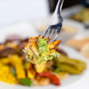 a fork holding a piece of broccoli