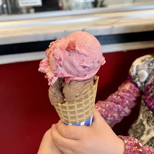Chocolate ice cream topped with strawberry ice cream