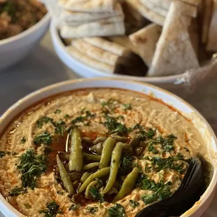 a bowl of hummus and pita chips