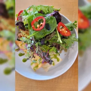 The fish special- fish on a bed of quinoa, salad, microgreens , fried pita and herb drizzle