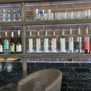 a leather chair in front of a brick wall