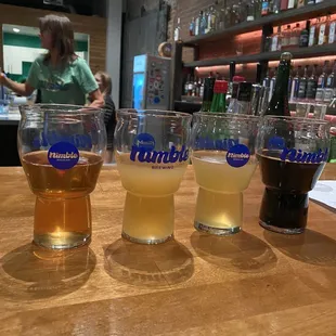 three glasses of beer on a bar