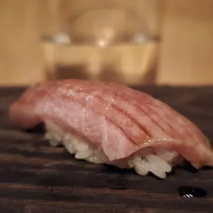 a piece of sushi on a cutting board