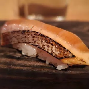 a piece of sushi on a cutting board