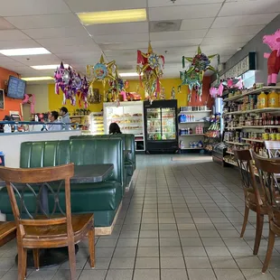 Seating, market items, and orders being taken (left rear area of photo)