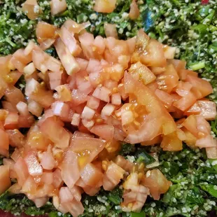 Delicious Tabouli with fresh tomatoes atop upon request.