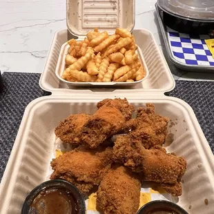 Fried chicken wings and fries.