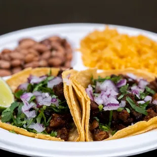 a plate of tacos and beans