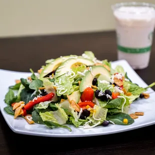 a plate of salad and a drink