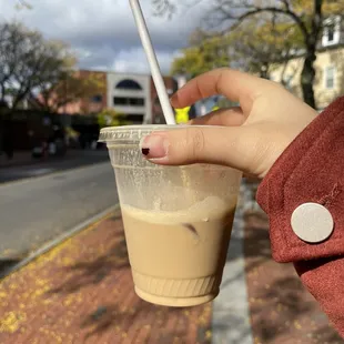 a hand holding a cup of coffee