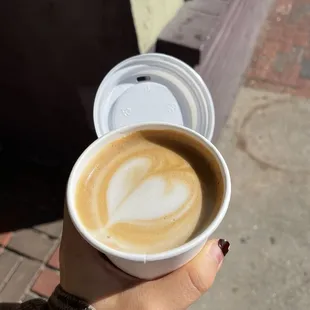 a person holding a cup of coffee