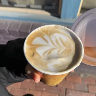 a person holding a cup of coffee