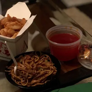 a bowl of noodles, a container of sauce, and a container of shrimp