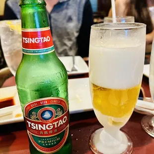 a bottle of tsingtao and a glass of beer