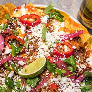 carnitas nachos with habanero salsa and crema