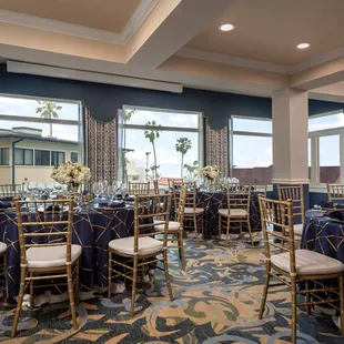 a banquet room set up with tables and chairs