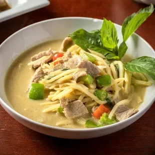 a bowl of noodles with meat and vegetables