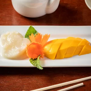 a plate of food with chopsticks