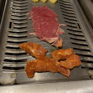 meat and vegetables on a grill