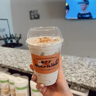 a hand holding a cup of coffee