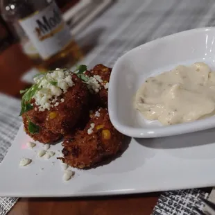 a plate of food and a bottle of beer