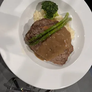 2slices of meatloaf over homemade mashed potatoes