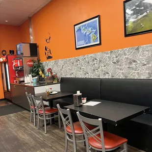 a dining area with tables and chairs