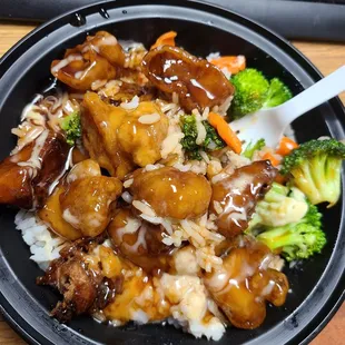 a plate of food with rice and broccoli