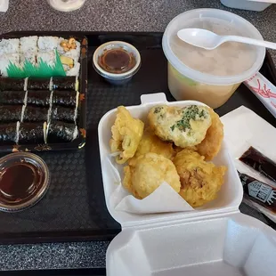 Two avocado rolls, one peanut and avocado roll, vegetable tempura, and miso soup.