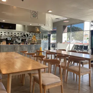 a dining area with tables and chairs
