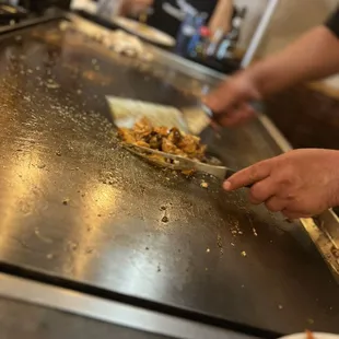 a person preparing food on a grill